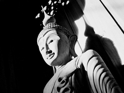 Black and white image of a Buddha statue.