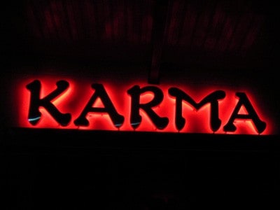 Red neon sign that says 'Karma'.