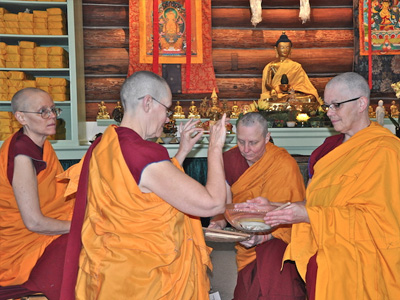 Ven. Semkye washing her hands, symbolizing purifying all defilements and nourishing all virtuous qualities, before accepting the Varsa stick.
