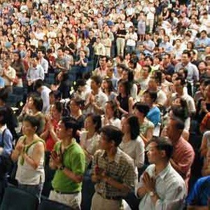 The audience standing with palm's together at Kreta Ayer People's Theatre, Singapore.