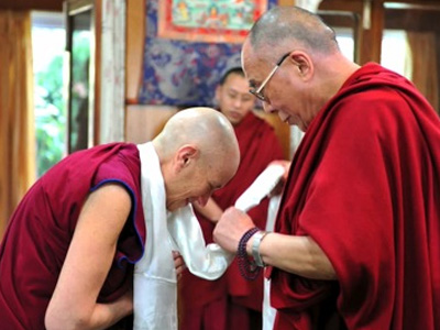 Venerable Chodron bowing to His Holiness the Dalai Lama.