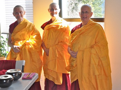 Ven. Samten, Ven. Tarpa and Ven. Jigme smiling happily.