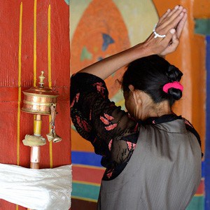 Woman with hands above head, prostrating.