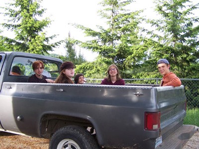 A group of young adult retreat ants in back of the abbey truck.