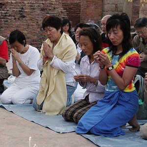 Lay people kneeling, taking precepts.