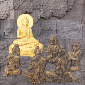 Buddha with five monks kneeling in front of him.