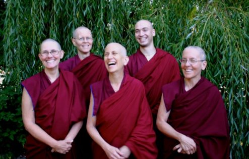 Venerable Chodron and Abbey monastics smiling happily.