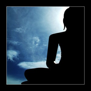 A statute of a giant buddha, showing the sky at the background.