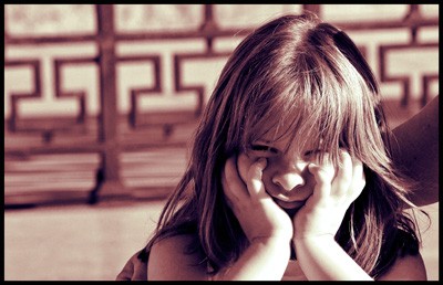 A small girl showing angry face