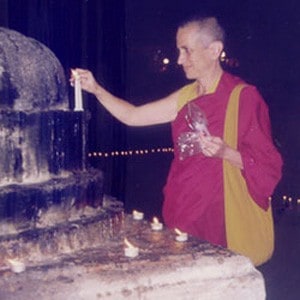 Venerable Thubten Chodron lighting a candle.
