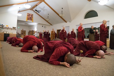 Tibetan buddhist monastics bowing and chanting.