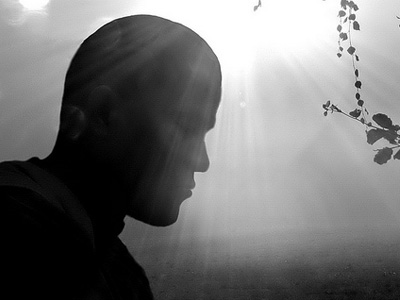 Silhouette of man with highlight behind his head.