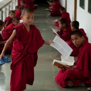 A small novice holding a piece of paper.