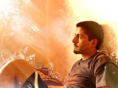 A man daydreaming looking a the sunshine shining on him.