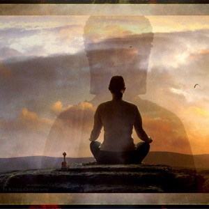 Woman meditating with a vague image of buddha in the background.