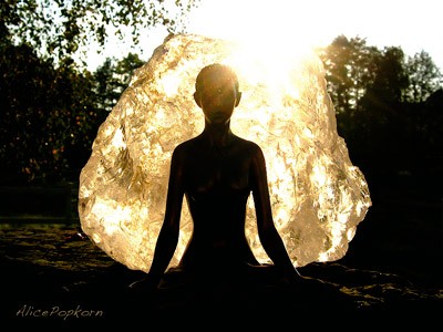 A big bubble wrapping a woman who is meditating.