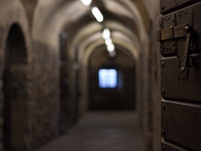 Old prison cells in dim light.