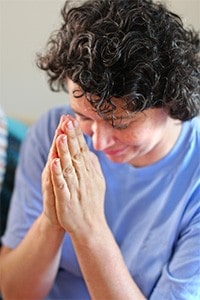 Woman with palms together.