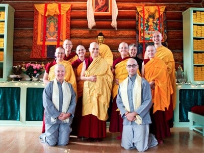 Group of monastics and the two anagarikas, standing with Venerable Chodron.