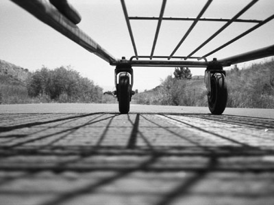 A below view of shopping cart and the front wheels.