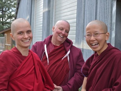 Venerables Jampa, Tsultrim, and Damcho, smiling.