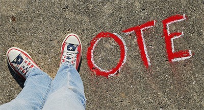 Shoes making the letter V in VOTE.