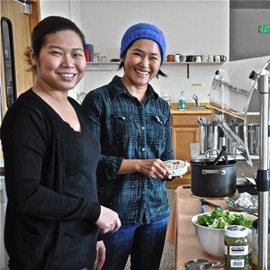 Mui and Kuni, Abbey guests, cooking together.