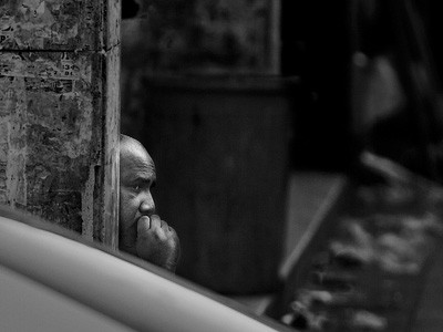 Black and white image of a man thinking.