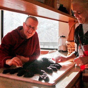 Ven. Jigme and a Dharma friend making a scorpion of seeds.