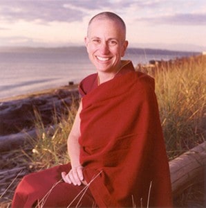 Venerable Chodron sitting by the ocean.