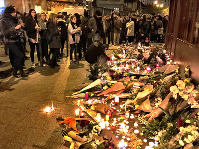 A group of people gathered at a candlelight memorial.