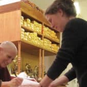 Venerable Chodron signs a book for a Dharma student at Tibet House Frankfurt.