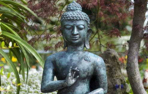 Statue of Buddha in garden.