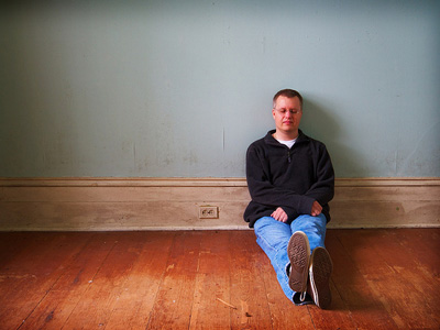 Man sitting on the floor in contemplation.