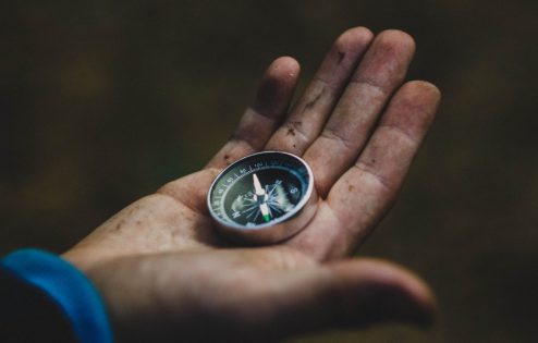 Open hand holding a compass