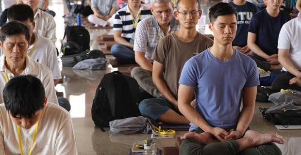 Students sitting in meditative posture.