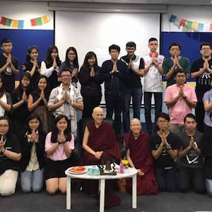 Venerable surrounded by students from SEGi College.