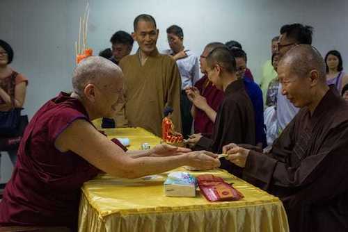 Venerable making a hand gesture while teaching.