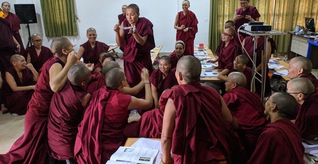 Tibetan nuns discussing physics experiments in class.