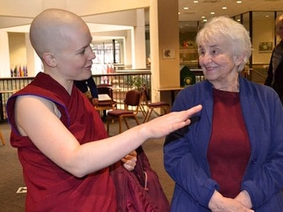 Venerable Lamsel smiling and talking to a friend.