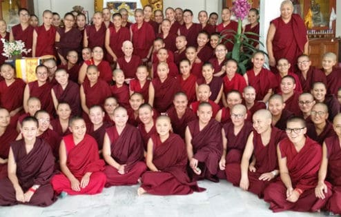 A large group of monastics posing for a photo.