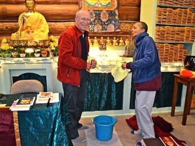 Ken Mondale at the Abbey setting up an altar with a fellow practitioner.