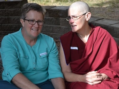 Nun and layperson sitting together and talking.