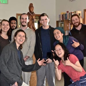 A large group of young people smiling while standing together for a photo.