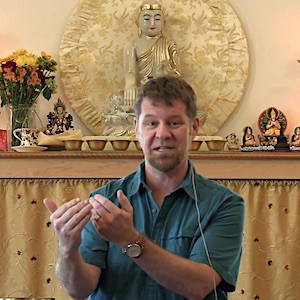 Dr. Russell Kolts teaching in front of the Buddha in Chenrezig Hall.