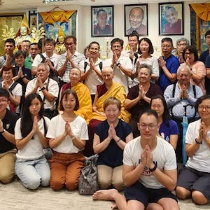 Group photo of many people with Venerables Chodron and Damcho in the center.