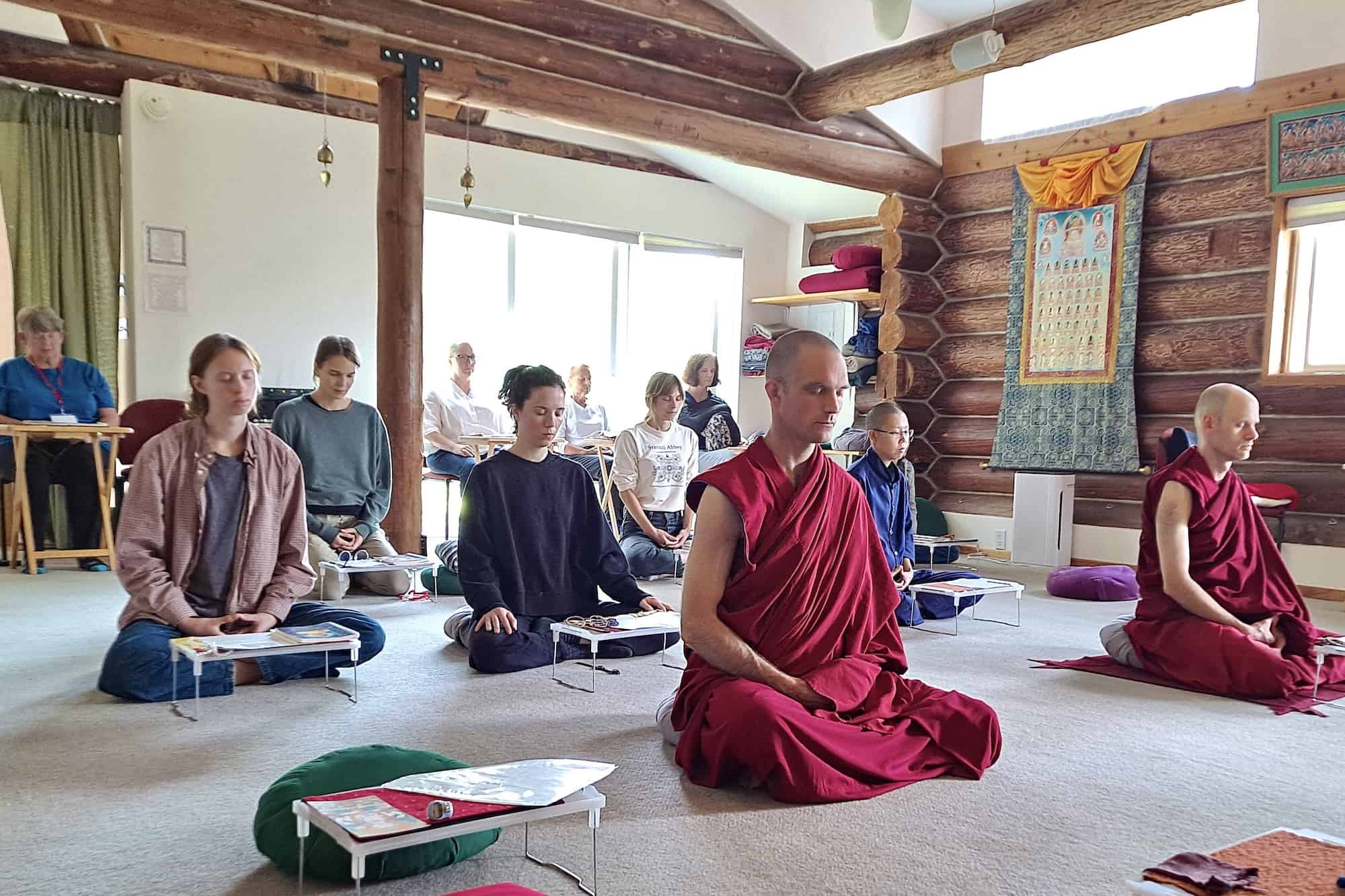 Group of monastics and laypeople meditating.