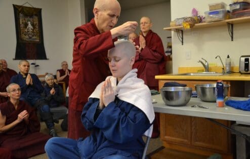 Venerable Thubten Chodron shaves the head of Rebecca Bradley at her novice ordination.