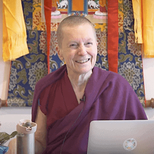 Venerable Sangye Khadro smiling while teaching in front of a thangka.