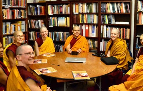 A group of shiksamanas in the Abbey library reading their precepts at the round table.